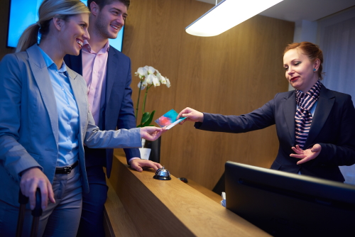 Couple on a business trip doing check-in at the hotel